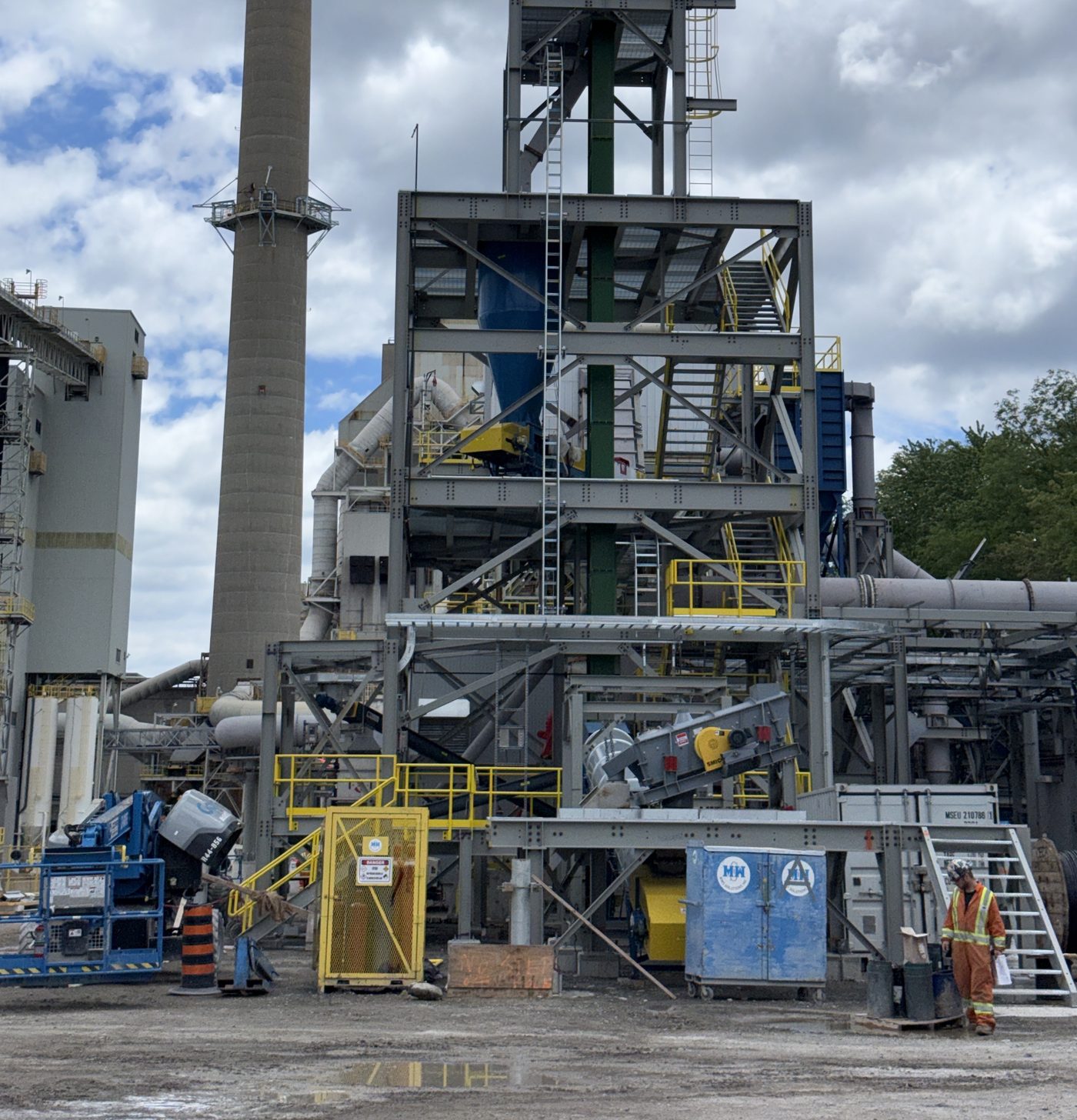 Process plant structure with a stack, steel platforms, ductwork and access stairs.